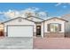 Newly built home with white siding, brick accents, and a two-car garage at 1217 S Desert View Pl, Apache Junction, AZ 85120