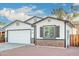 Newly built home with white siding, brick accents, and a two-car garage at 1217 S Desert View Pl, Apache Junction, AZ 85120