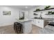 Modern kitchen with island, white cabinets, granite counters, and stainless steel appliances at 1217 S Desert View Pl, Apache Junction, AZ 85120