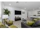 Open living space with gray sofas, green pillows, and a view into the kitchen at 1217 S Desert View Pl, Apache Junction, AZ 85120