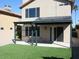 Spacious backyard with a covered patio and artificial turf at 1231 E Helena Dr, Phoenix, AZ 85022