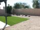 Landscaped backyard with artificial turf and gravel at 1231 E Helena Dr, Phoenix, AZ 85022