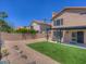 Landscaped backyard with grassy area and pergola at 1231 E Helena Dr, Phoenix, AZ 85022