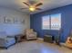 Cozy bedroom with blue accent wall and ceiling fan at 1231 E Helena Dr, Phoenix, AZ 85022