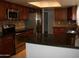 Kitchen with dark wood cabinets and granite countertops at 1231 E Helena Dr, Phoenix, AZ 85022