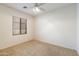 Small bedroom with ceiling fan and window coverings at 12947 W Chapala Dr, Sun City West, AZ 85375