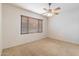 Bright bedroom with ceiling fan and neutral carpet at 12947 W Chapala Dr, Sun City West, AZ 85375