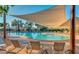 Large community pool with shade structure and lounge chairs at 12947 W Chapala Dr, Sun City West, AZ 85375