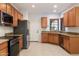 Kitchen with wood cabinets, granite counters, and stainless steel appliances at 12947 W Chapala Dr, Sun City West, AZ 85375