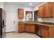 Kitchen with wood cabinets, granite countertops and a window at 12947 W Chapala Dr, Sun City West, AZ 85375