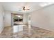 Living room with tile floors and sliding glass doors to a patio at 12947 W Chapala Dr, Sun City West, AZ 85375