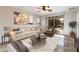 Living room with beige sofa, brown armchair, and patio access at 12947 W Chapala Dr, Sun City West, AZ 85375