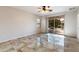 Bright living room with tile floors and sliding glass doors at 12947 W Chapala Dr, Sun City West, AZ 85375