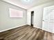 Well-lit bedroom with a large closet and wood-look flooring at 1325 W 7Th Ave, Mesa, AZ 85202