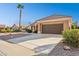 House exterior featuring a brown garage door and desert landscaping at 14203 W Rico Dr, Sun City West, AZ 85375