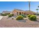 Tan house with a brown roof and desert landscaping at 14203 W Rico Dr, Sun City West, AZ 85375