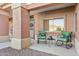 Relaxing front porch with rocking chairs and a small table at 14203 W Rico Dr, Sun City West, AZ 85375