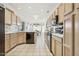 Bright kitchen with light-colored cabinets and black appliances at 14203 W Rico Dr, Sun City West, AZ 85375