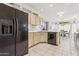 Kitchen boasts black appliances and light wood cabinets at 14203 W Rico Dr, Sun City West, AZ 85375