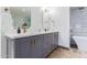 Double vanity bathroom with gray cabinets and marble flooring at 1422 W Colter St, Phoenix, AZ 85013