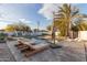 Relaxing pool area with lounge chairs and patio umbrella at 1422 W Colter St, Phoenix, AZ 85013