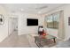 Bright living room featuring tiled floors, a ceiling fan, and a comfy chair at 155 N Lakeview Blvd # 100, Chandler, AZ 85225