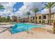 Community pool area with lounge chairs and palm trees at 155 N Lakeview Blvd # 100, Chandler, AZ 85225