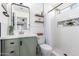 Modern bathroom with green vanity and walk-in shower at 15725 W Post Dr, Surprise, AZ 85374