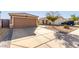 Two-car garage and driveway of a single-story house at 15725 W Post Dr, Surprise, AZ 85374