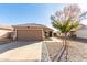 Single-story home with a two-car garage and landscaped front yard at 15725 W Post Dr, Surprise, AZ 85374