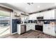 Modern kitchen with white cabinets, blue tile backsplash, and stainless steel appliances at 15725 W Post Dr, Surprise, AZ 85374