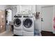 Bright laundry room, featuring a washer, dryer, and ample storage at 15725 W Post Dr, Surprise, AZ 85374