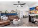 Living room with a brown sectional sofa and wood-look floors at 15725 W Post Dr, Surprise, AZ 85374