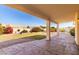 Covered patio overlooking a grassy backyard with desert landscaping at 16146 E Gleneagle Dr, Fountain Hills, AZ 85268