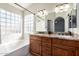 Bathroom with granite countertop, double vanity, and glass block window at 16146 E Gleneagle Dr, Fountain Hills, AZ 85268