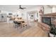 Open dining area with wood flooring, brick fireplace, and kitchen views at 1624 W Lawrence Rd, Phoenix, AZ 85015