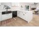 Modern kitchen with white cabinets, a farmhouse sink, and a large island at 1624 W Lawrence Rd, Phoenix, AZ 85015