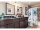 Double vanity bathroom with dark brown cabinets at 16813 S 37Th Way, Phoenix, AZ 85048