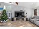 Living room featuring a large TV, fireplace, and Christmas tree at 16813 S 37Th Way, Phoenix, AZ 85048