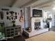 Living room with a whitewashed brick fireplace and eclectic decor at 1707 E Mclellan Blvd, Phoenix, AZ 85016