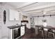 Modern kitchen with white cabinets, wine cooler and breakfast bar at 1707 E Mclellan Blvd, Phoenix, AZ 85016