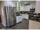 Modern kitchen with white cabinets, stainless steel appliances, and granite counters at 1707 E Mclellan Blvd, Phoenix, AZ 85016