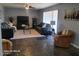 Living room features tile floors, two sofas, and a large TV at 1707 E Mclellan Blvd, Phoenix, AZ 85016