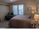 Comfortable bedroom with large windows and a ceiling fan at 17200 W Bell Rd # 1599, Surprise, AZ 85374