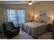 Bright bedroom featuring a comfy recliner and large windows at 17200 W Bell Rd # 1599, Surprise, AZ 85374