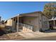 Tan mobile home with carport and ramp access at 17200 W Bell Rd # 1599, Surprise, AZ 85374