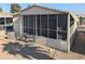 Tan mobile home with screened porch and small grill at 17200 W Bell Rd # 1599, Surprise, AZ 85374