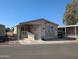 Tan mobile home with carport and ramp access at 17200 W Bell Rd # 1599, Surprise, AZ 85374