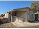 Tan mobile home with carport and ramp access at 17200 W Bell Rd # 1599, Surprise, AZ 85374