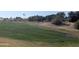 View of a lush green golf course with sand traps and distant homes at 17200 W Bell Rd # 1599, Surprise, AZ 85374